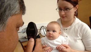 Mandatory Credit: Photo by Medicimage/REX/Shutterstock (4326892a) A GP using an ophthalmoscope to examine the health of a baby's retina and vitreous humour. VARIOUS