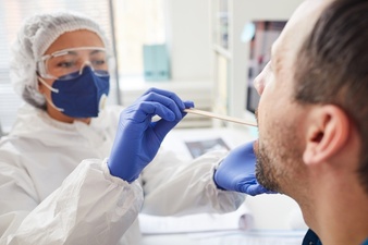 mature-man-opening-the-mouth-while-doctor-in-protective-clothing-examining-his-throat-during-medical-exam-at-hospital_249974-2969