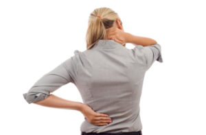 Woman with back pain isolated over a white background